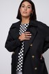 Trench-coat oversized. Col à revers. Double rangée de boutons et ceinture à nouer.