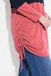 T-shirt long en coton bio. Col montant, manches longues et cordon de serrage.