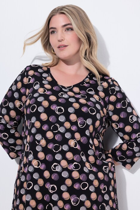 T-shirt long, motif à pois. Col en V et manches 3/4. Coupe évasée