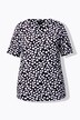 T-shirt à manches courtes. Tissu au tombé fluide imprimé pois. Décolleté en cœur