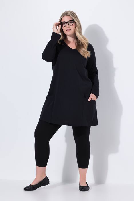 Maglia dal taglio lungo e svasato con tasche, scollo a V e maniche lunghe
