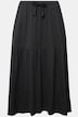 Jupe en jersey texturé. Coupe évasée et volant. Taille élastique