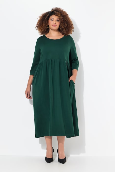 Robe maxi en jersey, avec poches. Coupe trapèze évasée. Décolleté rond et manches 3/4.