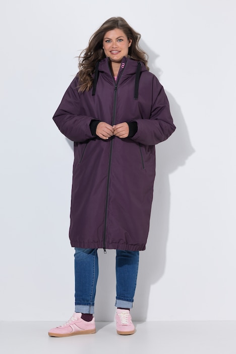 Veste technique oversize à capuche. Doublure polaire bouclée. Fermeture éclair à double sens