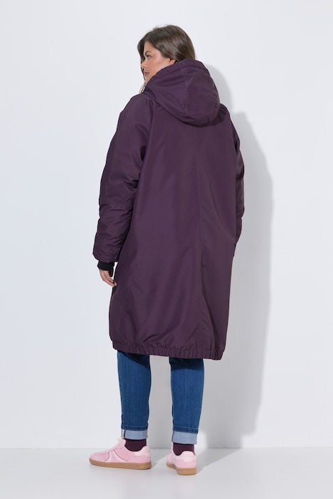 Veste technique oversize à capuche. Doublure polaire bouclée. Fermeture éclair à double sens