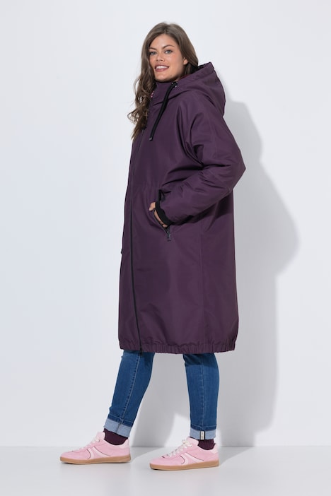 Veste technique oversize à capuche. Doublure polaire bouclée. Fermeture éclair à double sens