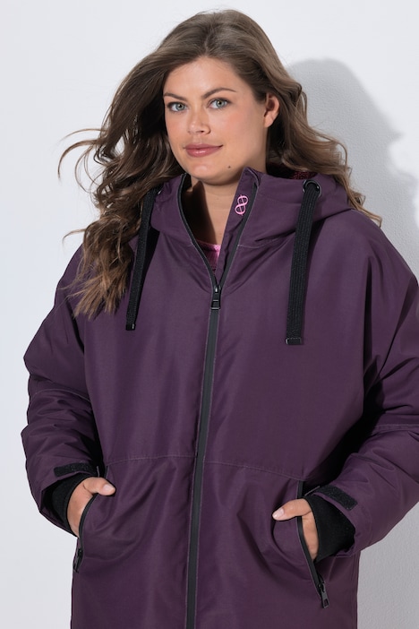 Veste technique oversize à capuche. Doublure polaire bouclée. Fermeture éclair à double sens
